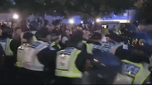 thumbnail - 경찰이 아동 성범죄 혐의를 인정한 리 코믈리를 경찰차로 연행하자 군중이 휴대전화로 촬영하며 뒤따랐다. 출처=COST·PPI 페이스북