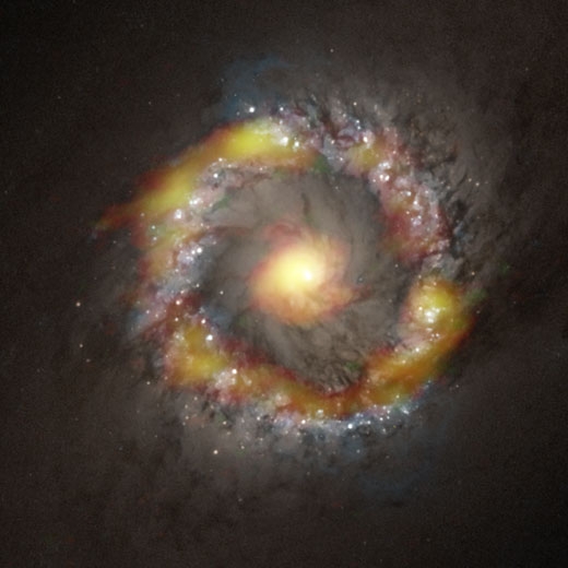 알마 망원경으로 관측한 NGC1097 중심부. 시안화수소(HCN) 분포를 빨간색으로 포르밀리움(HCO+) 분포를 녹색으로 표현하고 가시광선 이미지에 합성. HCN과 HCO + 모두가 존재하는 곳은 노란색으로 보인다.