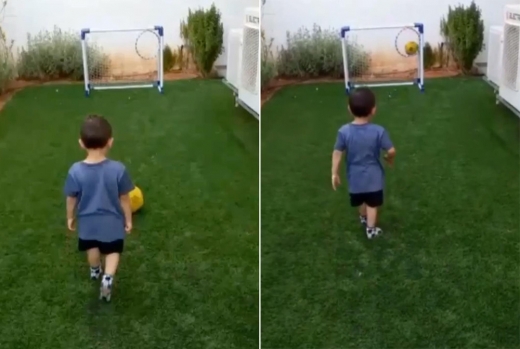 아이는 공을 차서 축구 골대 속 동그라미 안으로 정확히 골인시킨다.