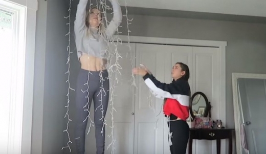 이날 루드닉은 촬영에 참여한 모델 에밀리 브라운과 함께 창문이 있는 거실 천장에 크리스마스 조명 장식을 주렁주렁 달았다.