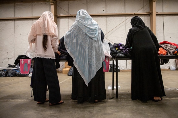 포트 맥코이에 머물고 있는 아프가니스탄 난민들이 7일 미군 병사와 비정부기구 민간인이 기부한 신발과 옷을 살펴보고 있다./포트 맥코이 제공