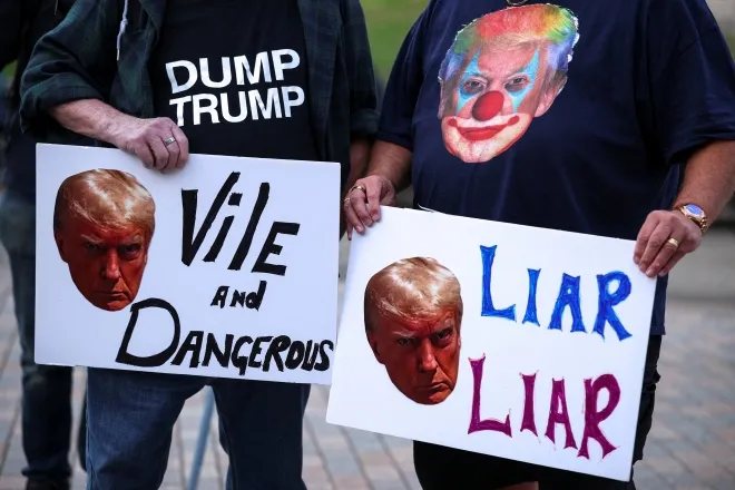 도널드 트럼프 미국 대통령의 영국 국빈 방문을 앞두고 16일(현지시간) 윈저에서 열린 시위 현장. 한 참가자는 가슴에 ‘덤프 트럼프’ 글귀가 적힌 티셔츠를 입고 “사악하고 위험하다”(Vile and Dangerous)라는 피켓을 들었다. 옆 참가자는 트럼프 얼굴을 삐에로로 합성한 그림이 새겨진 티셔츠를 입고 “거짓말쟁이”(Liar Liar)라는 피켓을 들고 항의에 동참했다. 로이터 연합뉴스