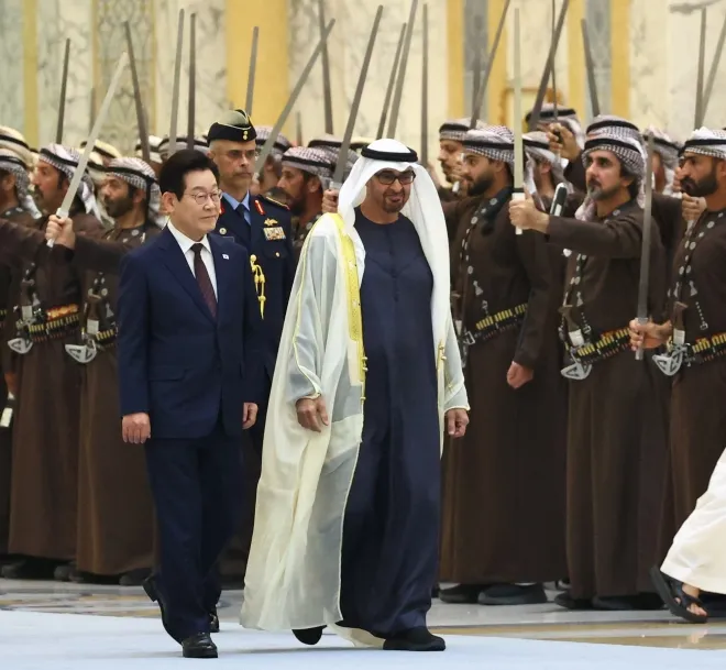 이재명 대통령이 18일(현지시간) 아랍에미리트(UAE) 아부다비 대통령궁에서 열린 국빈 방문 공식 환영식에서 무함마드 빈 자이드 알 나흐얀 UAE 대통령과 사열대로 이동하고 있다.  연합뉴스